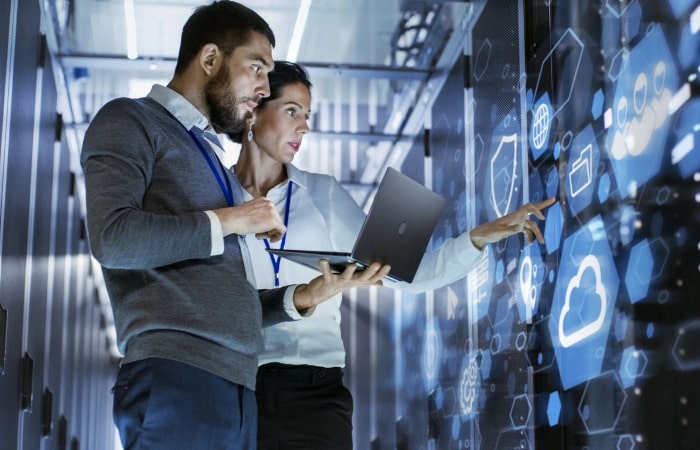 Two people are looking at a computer screen.